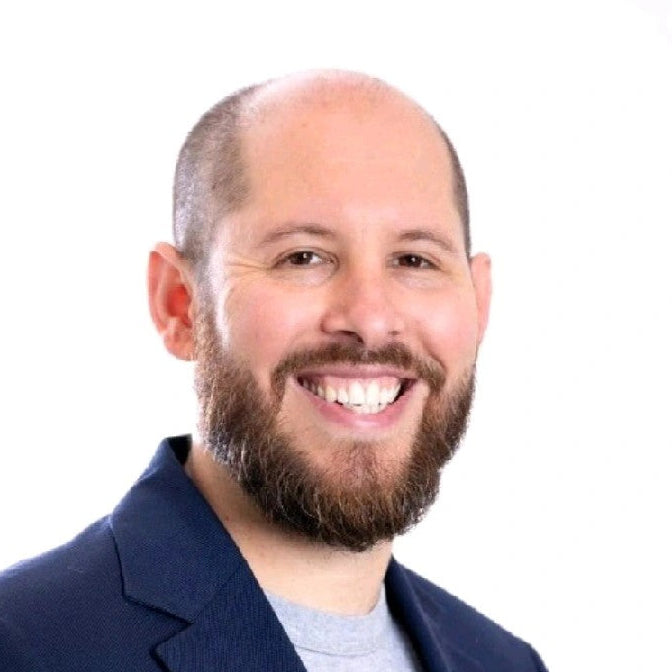 Man with a beard and blue jacket on a white background